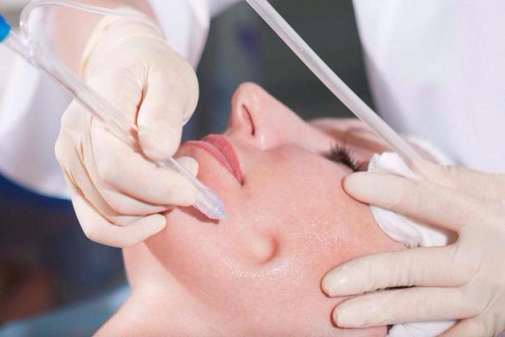 a woman getting facial treatment